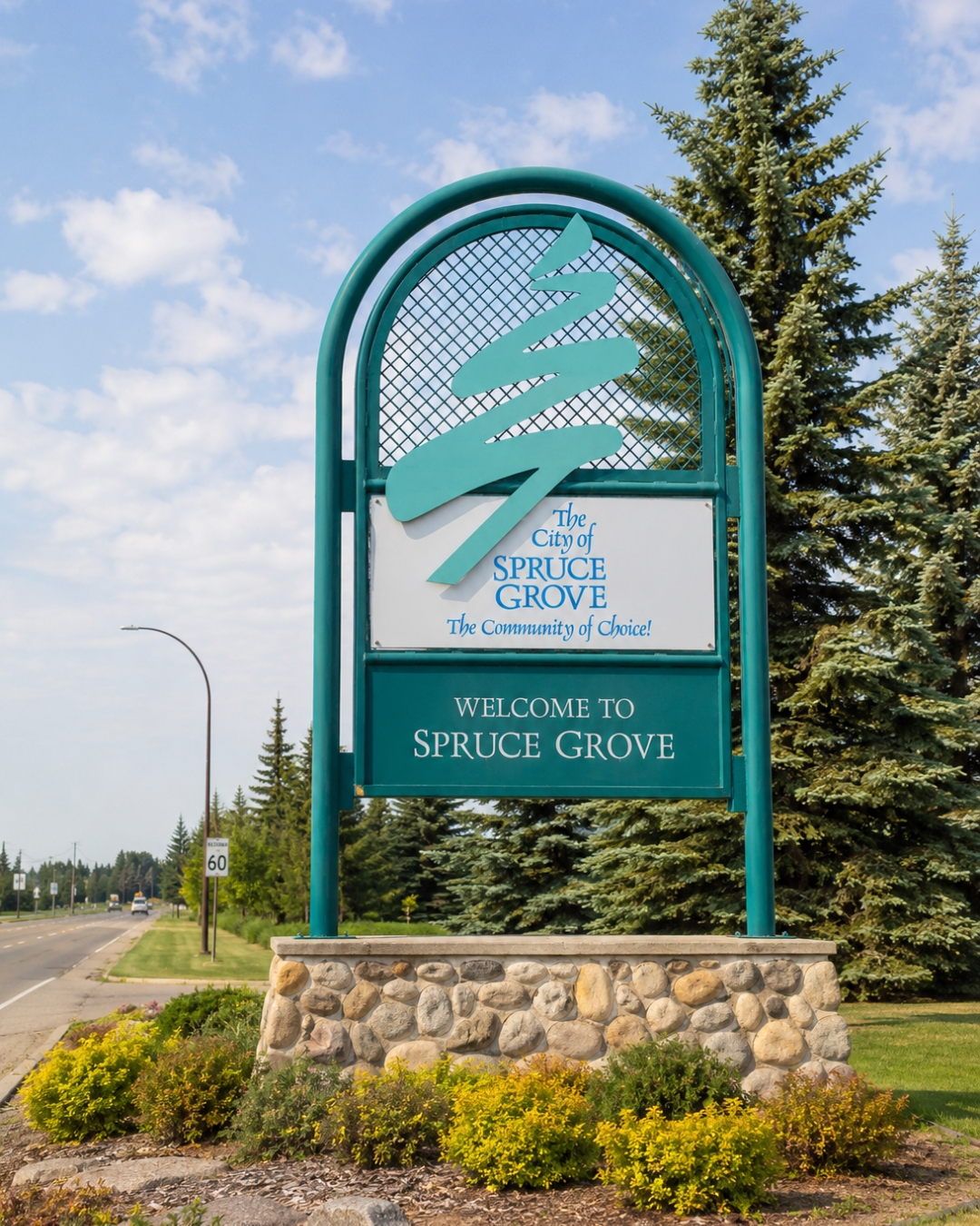 Welcome to Spruce Grove roadside sign beside a tree-lined road in Alberta with Peace Power providing electricity and natural gas services.