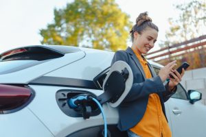 Electric vehicle connected to a charging station, illustrating the electricity consumption and charging requirements of EV ownership.